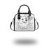 Happy corgi with butterfly on its nose in the garden shoulder handbag