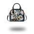Painting of calla lilies in bold geometric shapes shoulder handbag