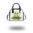 Smiling frog sitting on a pond shoulder handbag