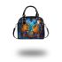 Two colorful owls sitting on the edge of an ornate mirror shoulder handbag