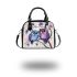 Two cute purple and blue owls sitting on the branch shoulder handbag