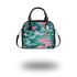 Vibrant pattern of pink and turquoise butterflies shoulder handbag